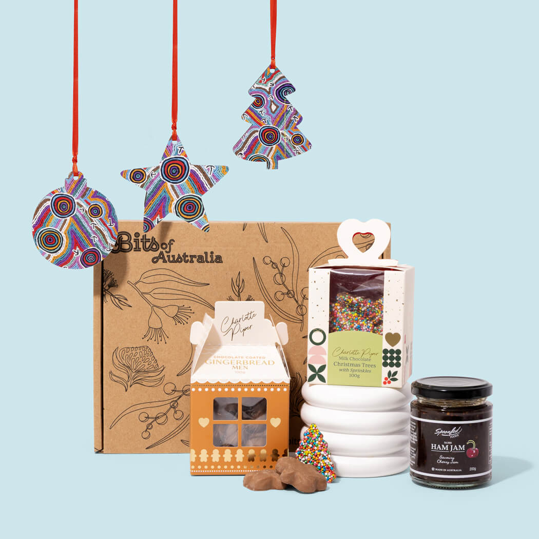Australian Christmas gift box with Aboriginal art wooden decorations, chocolate Christmas trees, gingerbread and Ham Jam