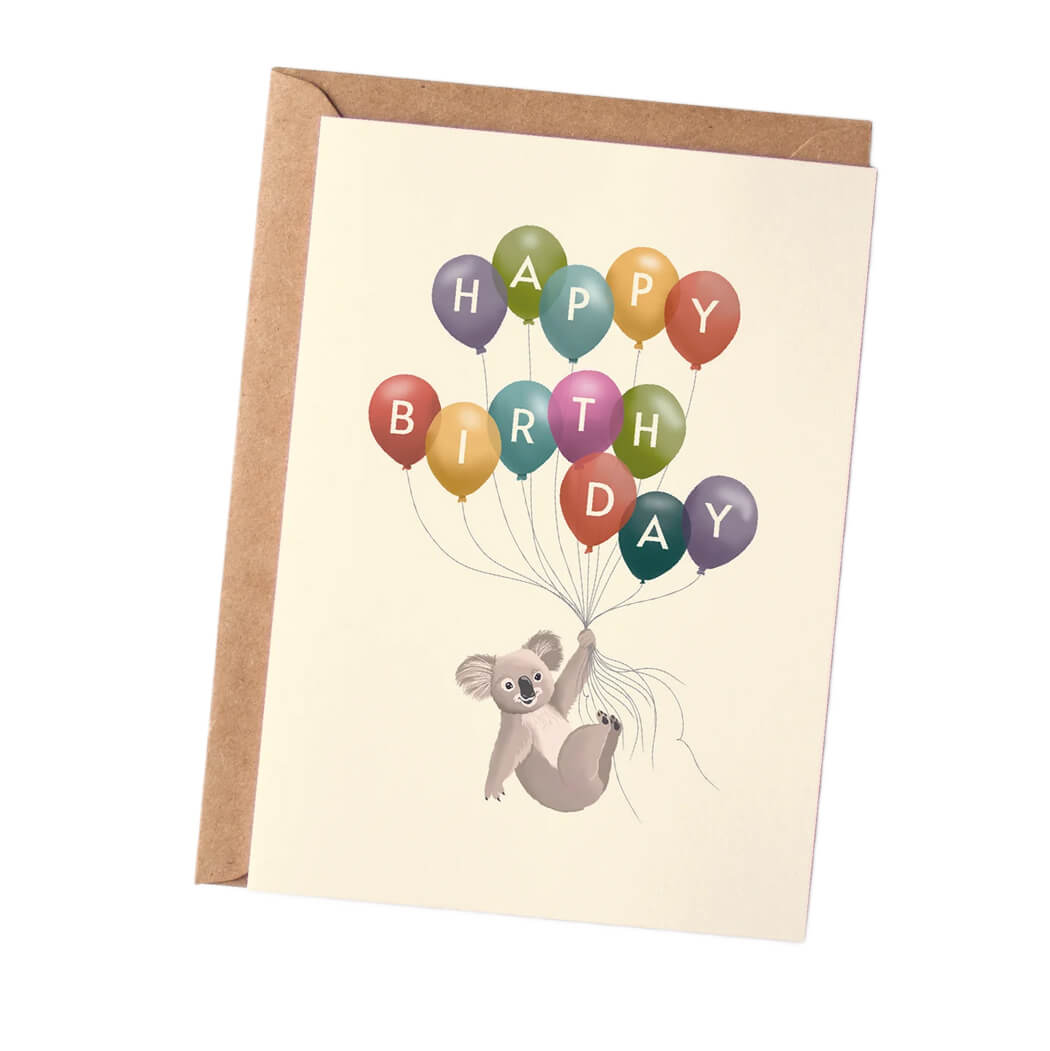 Birthday card with a koala holding balloons spelling 'Happy Birthday' on a beige background. Australian Made
