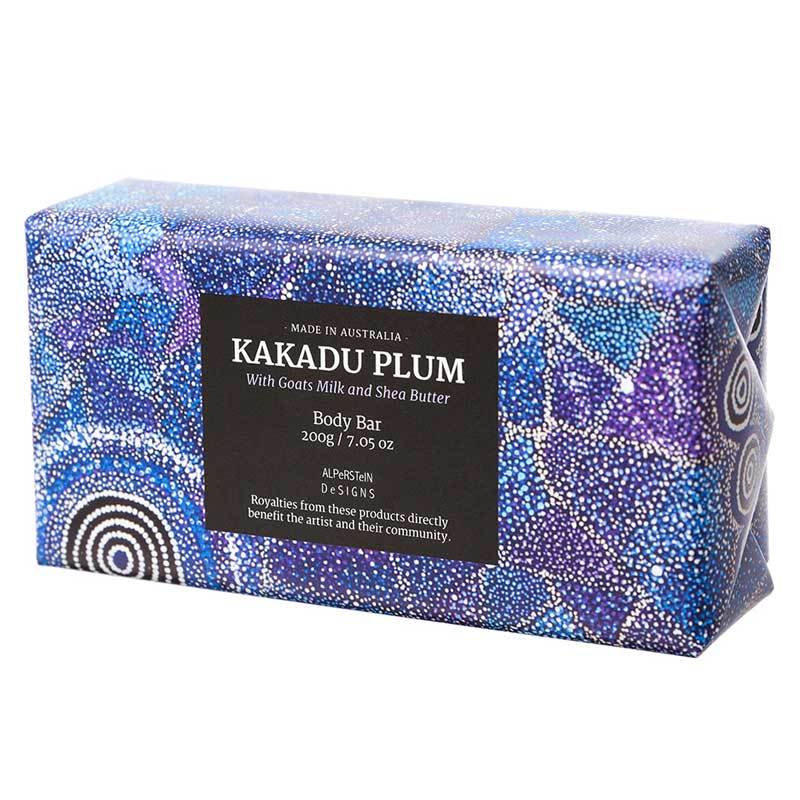 A bar of soap with blue and white Aboriginal art design packaging, labeled 'Kakadu Plum Body Bar', made in Australia.